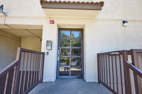 Los Angeles apartment for rent - A building entrance with a glass door and a sign that says "No Smoking".