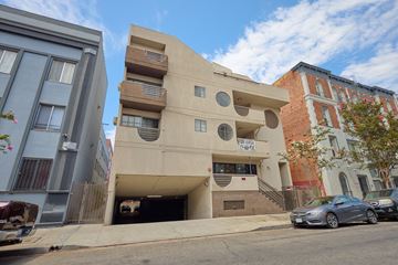Los Angeles apartment for rent - A modern building with a unique design is situated on a street corner.