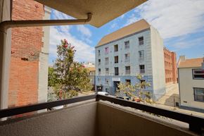 Los Angeles apartment for rent - A balcony overlooks a tree and apartment buildings.