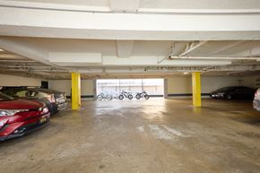 Los Angeles apartment for rent - A parking garage with a red car on the left and a black car on the right.
