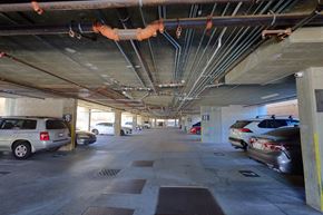 Los Angeles apartment for rent - A parking garage with cars parked on the ground floor.