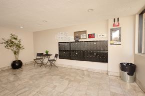 Los Angeles apartment for rent - A room with a table and chairs and a mailbox.