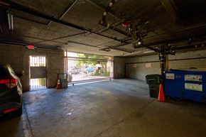 Los Angeles apartment for rent - A large empty garage with a car parked on the left side.