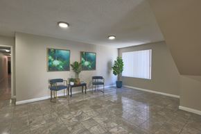 Los Angeles apartment for rent - A room with a table, chairs, and two potted plants.
