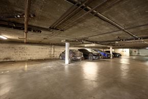 Los Angeles apartment for rent - A parking garage with a few cars parked.