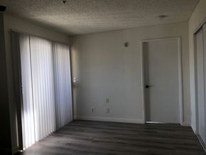 Los Angeles apartment for rent - an empty living room with a large window and a door