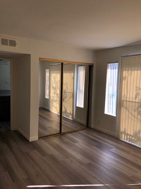 Los Angeles apartment for rent - an empty living room with wooden floors and sliding glass doors