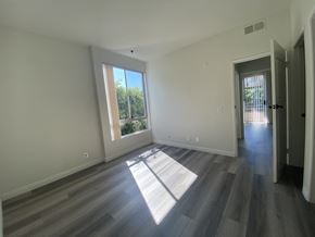 Los Angeles apartment for rent - an empty living room with wooden floors and a window