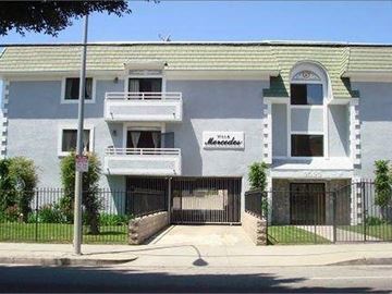 Los Angeles apartment for rent - a white house with a black fence and a gate