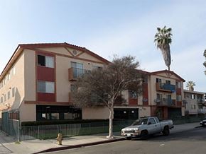 Los Angeles apartment for rent - an apartment building with a palm tree and a truck parked in front