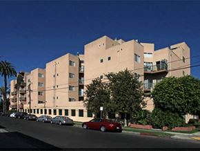 Los Angeles apartment for rent - a large building with cars parked in front of it