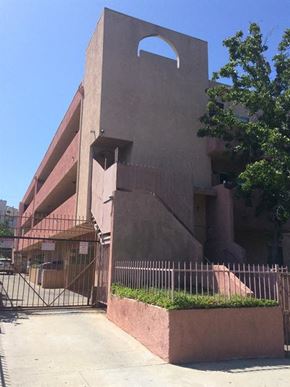 Los Angeles apartment for rent - a tall building with a fence and a gate