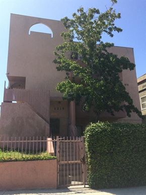 Los Angeles apartment for rent - a building with a gate and a tree in front of it
