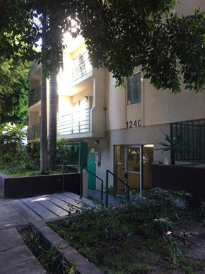 Los Angeles apartment for rent - the front of an apartment building with trees and a sidewalk