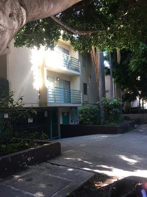 Los Angeles apartment for rent - an apartment building with a sidewalk and trees