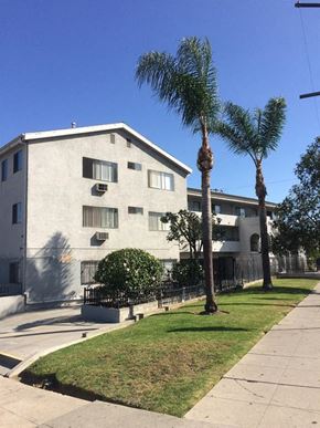 Los Angeles apartment for rent - an apartment building with palm trees in front of it