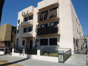 Los Angeles apartment for rent - a white building with a black fence in front of it