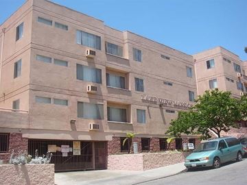 Los Angeles apartment for rent - a large building with a car parked in front of it