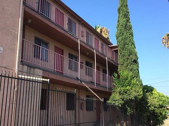 Los Angeles apartment for rent - an apartment building with a tree and a fence