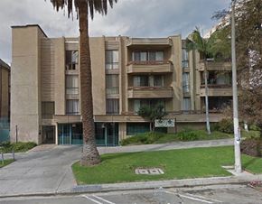Los Angeles apartment for rent - an apartment building with a palm tree in front of it