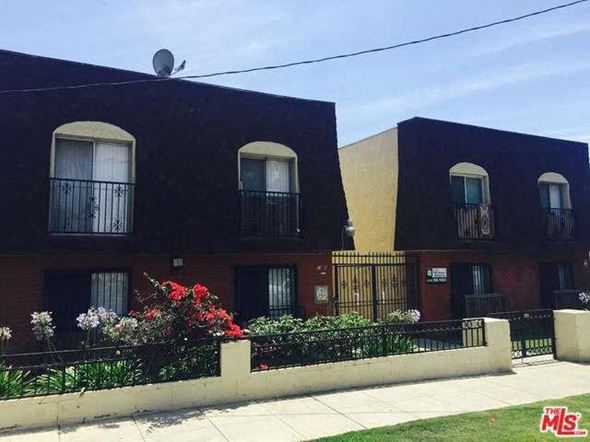 Los Angeles apartment for rent - a building with a fence and flowers in front of it