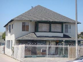 Los Angeles apartment for rent - A white house with a black roof and a white fence.