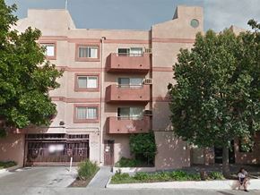 Los Angeles apartment for rent - an apartment building with pink walls and trees