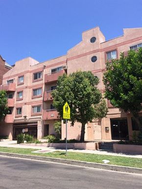 Los Angeles apartment for rent - a yellow street sign in front of a building