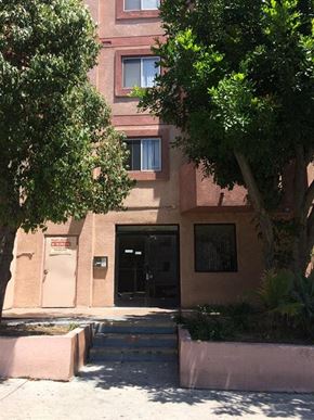 Los Angeles apartment for rent - a building with a door and a tree in front of it