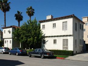 Los Angeles apartment for rent - a white building with cars parked in front of it