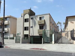 Los Angeles apartment for rent - an apartment building with a fence and a gate