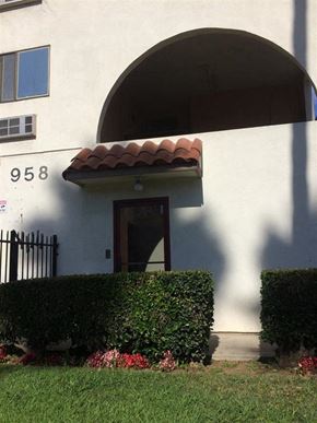 Los Angeles apartment for rent - a building with a door and hedges in front of it