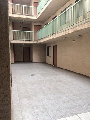 Los Angeles apartment for rent - the hall of an apartment building with a tile floor and a balcony