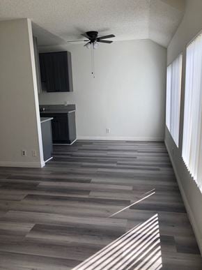 Los Angeles apartment for rent - a empty living room with wooden floors and a ceiling fan
