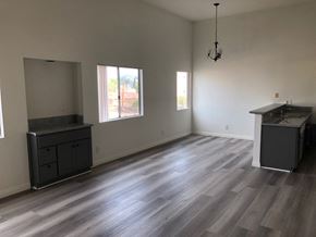 Los Angeles apartment for rent - an empty living room with hardwood floors and a kitchen