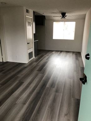 Los Angeles apartment for rent - an empty living room with hardwood floors and a ceiling fan