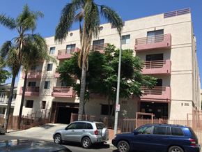Los Angeles apartment for rent - an apartment building with cars parked in front of it