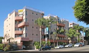 Los Angeles apartment for rent - a large apartment building with cars parked on the street