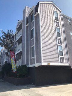 Culver City apartment for rent - a tall building with a red sign in front of it