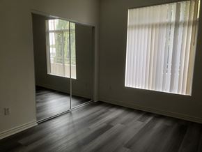 Los Angeles apartment for rent - A room with a sliding glass door and a window with blinds.