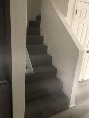 Los Angeles apartment for rent - A staircase with a white railing and grey carpet.