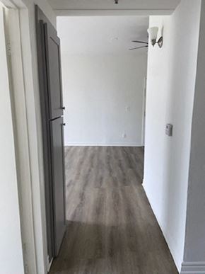 Los Angeles apartment for rent - a room with white walls and wooden floors and a door