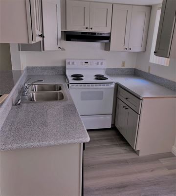 Los Angeles apartment for rent - a kitchen with white appliances and gray counter tops
