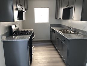 Los Angeles apartment for rent - an empty kitchen with stainless steel counters and a sink
