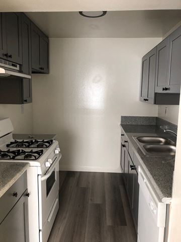 Los Angeles apartment for rent - an empty kitchen with white appliances and wood flooring