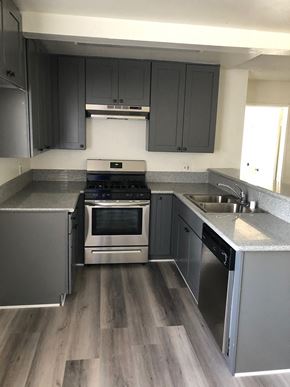 Los Angeles apartment for rent - an empty kitchen with stainless steel appliances and gray cabinets