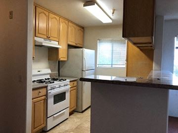 Los Angeles apartment for rent - a kitchen with white appliances and wooden cabinets