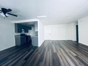 Los Angeles apartment for rent - an empty living room with wood floors and a kitchen