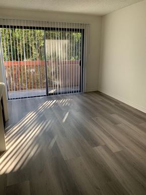Los Angeles apartment for rent - an empty living room with wood flooring and a window