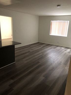 Los Angeles apartment for rent - an empty living room with wooden floors and a window